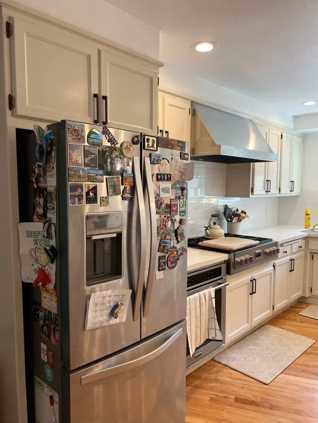 Cream cabinet kitchen with custom range hood remodeled by Valley Home Construction