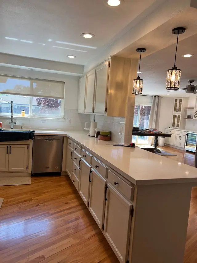 Long kitchen island with pendant lights designed and built by Valley Home Construction