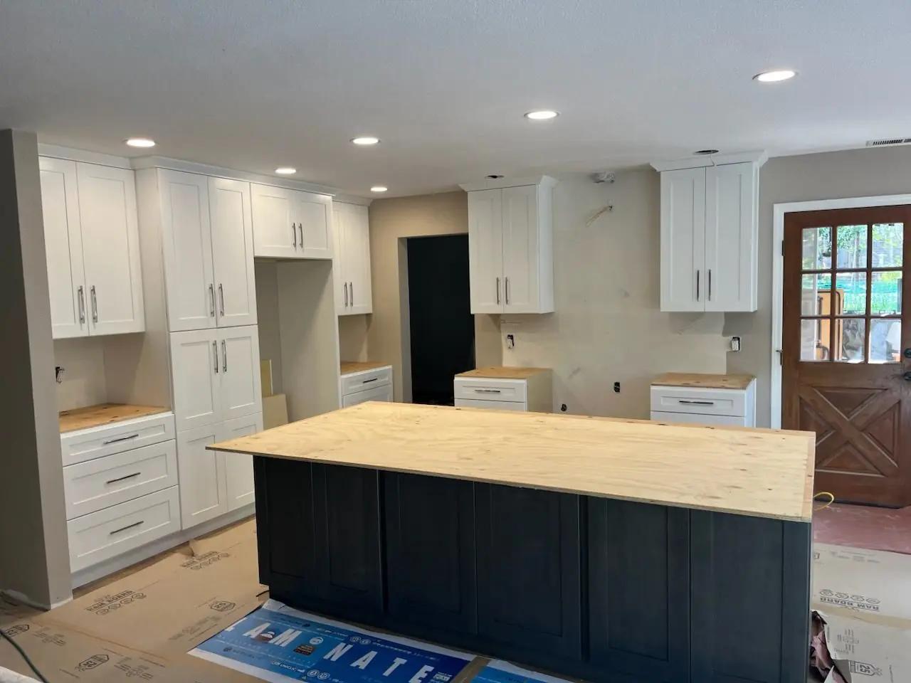 Kitchen mid-remodel with new cabinets installed and island template in place
