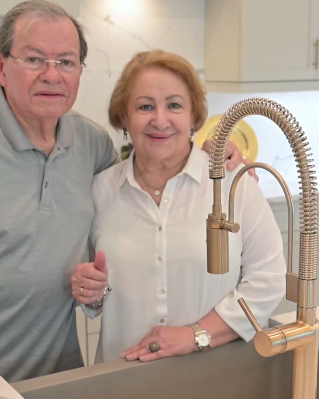 A couple standing in their finished kitchen