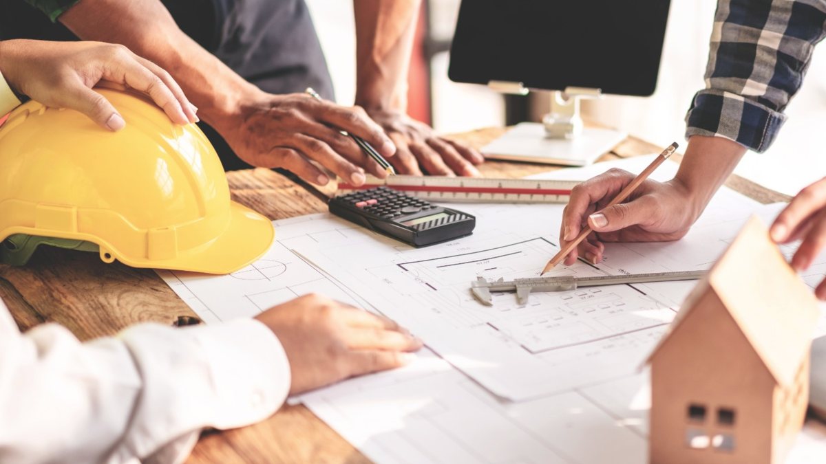 Going over building plans at a table before the permit is filed