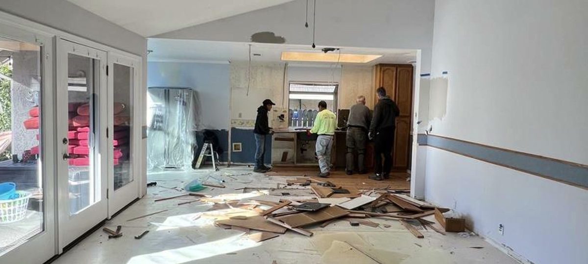 Our crew tearing out an old kitchen floor on demo day