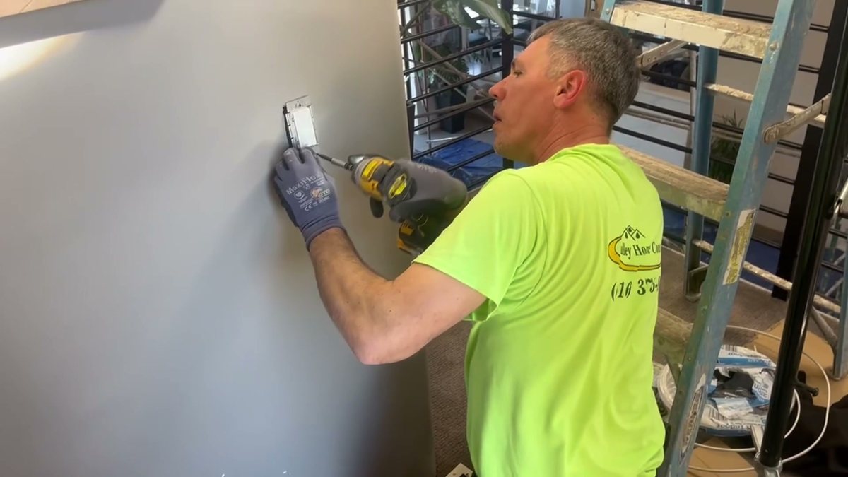 One of our crew installing an outlet during a build
