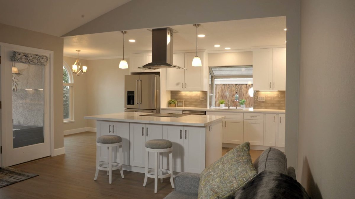 Finished white kitchen with an island at the final walkthrough